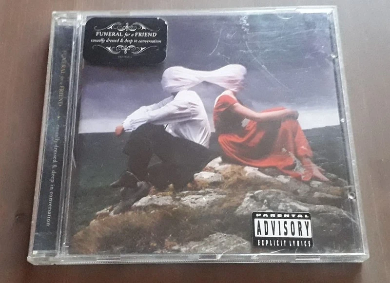 CD Funeral for a friend - casually dressed & deep in conversation