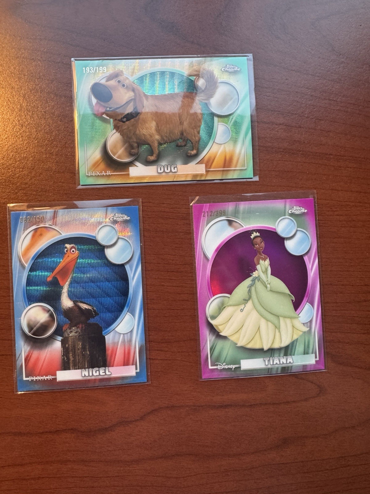Lotto 3 carte Disney Topps Chrome 2026 - Nigel /150 Scavate /199 Tiana /399