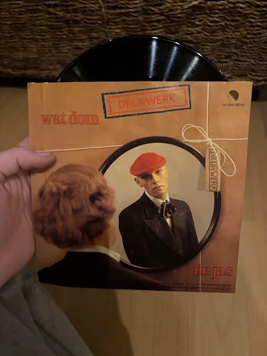 7" Vinyl Single Drukwerk - Wat Dom / De Jas (EMI)
