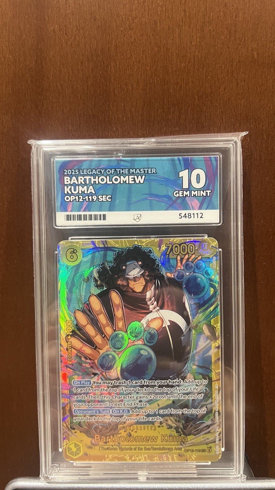 Bandai One Piece Bartholomew Kuma OP12-119 SEC Foil Graded 2025