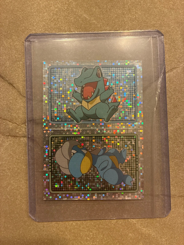 Merlin series 7 holo sticker Totodile en Bagon