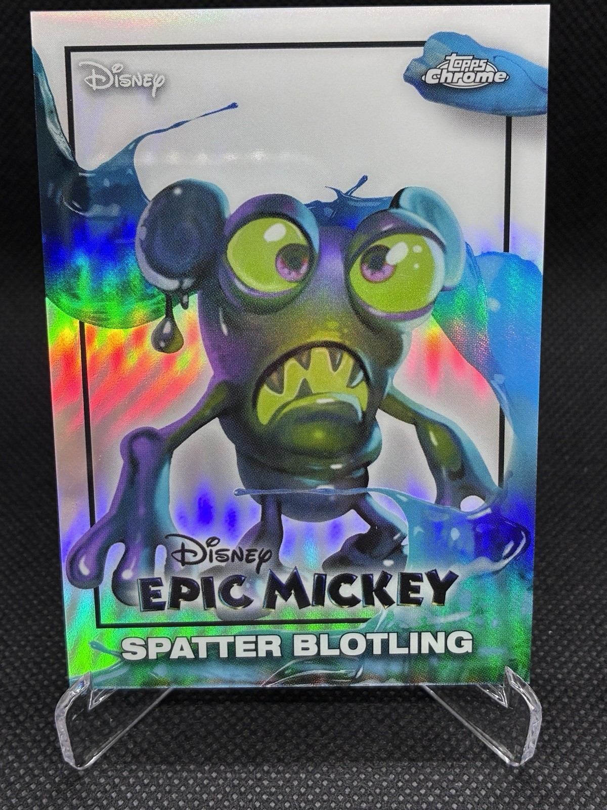 Scheda rifrattore 2026 Topps Disney Chrome Neon EM-18 EPIC MICKEY Spatter Blotling