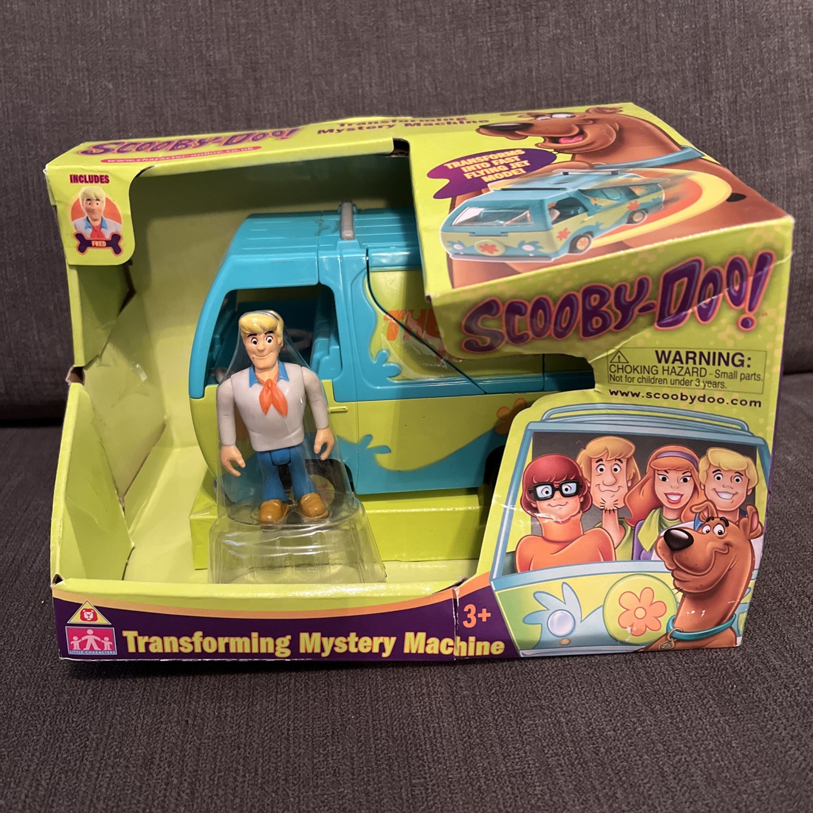 SCOOBY DOO TRANSFORMING MYSTERY MACHINE 2,5" FRED FIGURE SCATOLA DANNEGGIATA