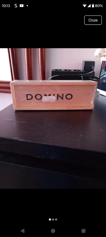 Classic dominoes set housed in a wooden box with a sliding lid.