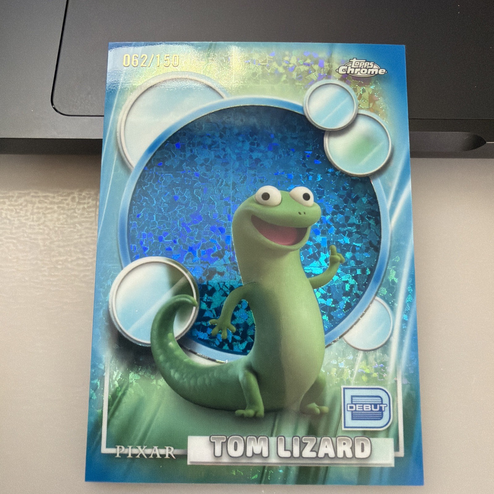 2026 Topps Chrome Pixar - Tom Lizard  Blue Mini-Diamond Refractor /150