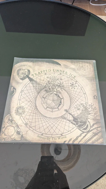 Trapped Under Ice – Secrets Of The World – LP Bronze/Black Splatter – 3rd Press /1000 – 2009