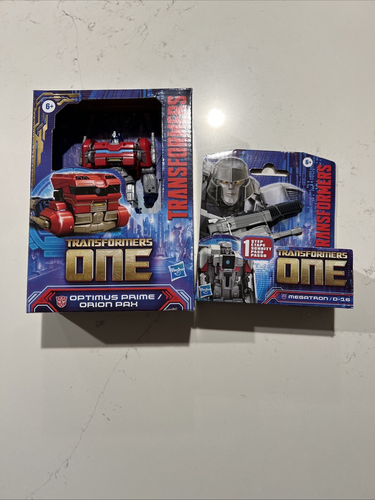 Transformers ONE Changer Deluxe Optimus Prime Orion Pax & Megatron D-16 nuovo