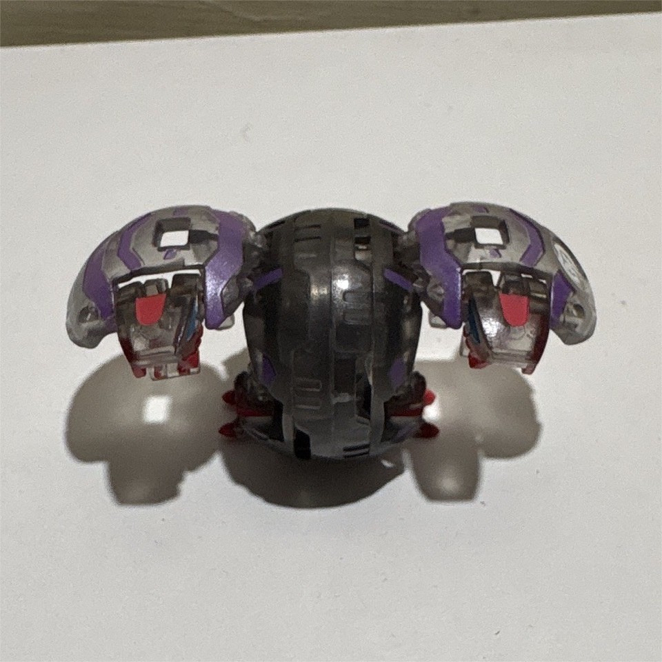 Mini action figure trasformabile veicolo/creatura, colori viola e nero