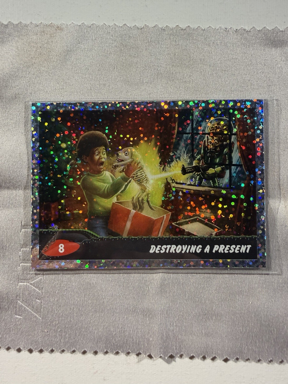 2026 Topps Mars Attacks Xmas Destroying A Present Sparkle Parallel #72/75