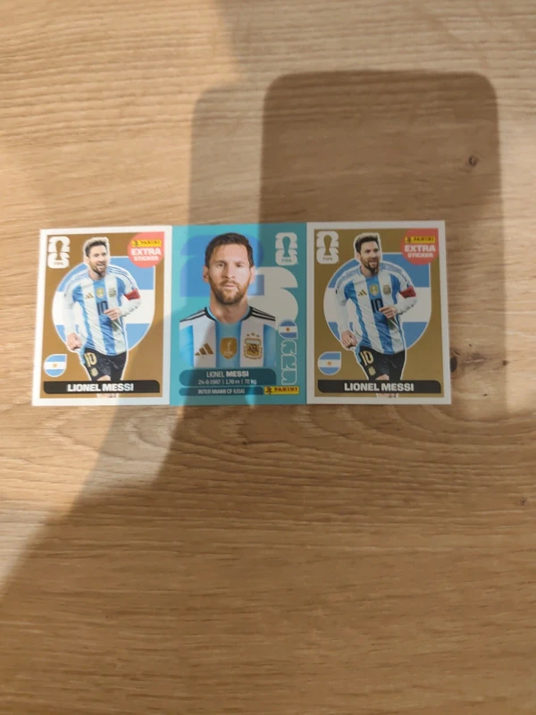 2 gold and bronze card of messi panini 2026 and messi basic argentina panini